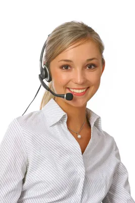 A helpful receptionist wears a headset and gives a friendly smile